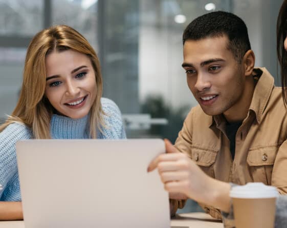 Two students reviewing options on a laptop